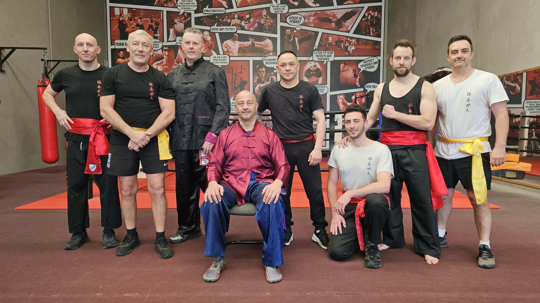 Eight members of the Wing Chun Universe instructor team posing together at the Mornington academy